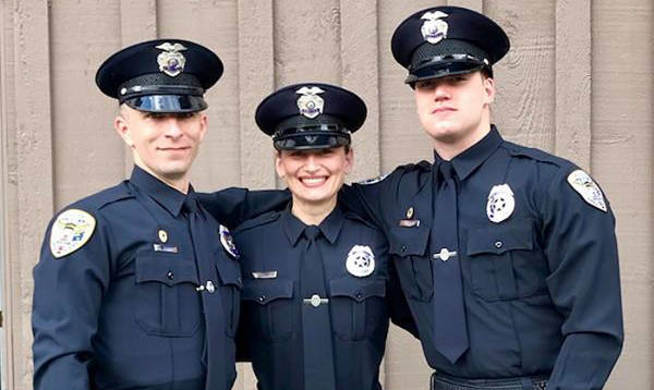 New Juneau Police Department officers (from left) Ron Shriver, Mattie Rielly and Joe Paden pose after their graduation from the Public Training Academy in Sitka on Friday, June 8, 2018. (Juneau Police Department | Courtesy Photo)