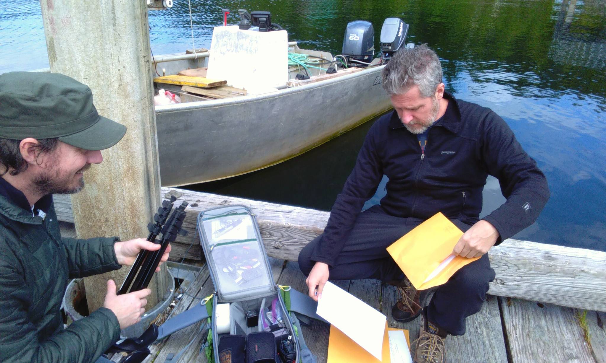 Daniel, left, packs up camera equipment and Travis, right, pulls out releases for Jamie to sign on the dock in Meyers Chuck. Tara Neilson | For the Capital City Weekly