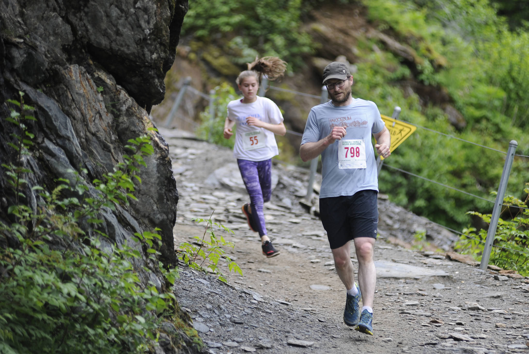 Steve Morley leads Maisy Morley down Perseverance Trail during the Perseverance Trail Run/Ben Blackgoat Memorial on Saturday. (Nolin Ainsworth | Juneau Empire)