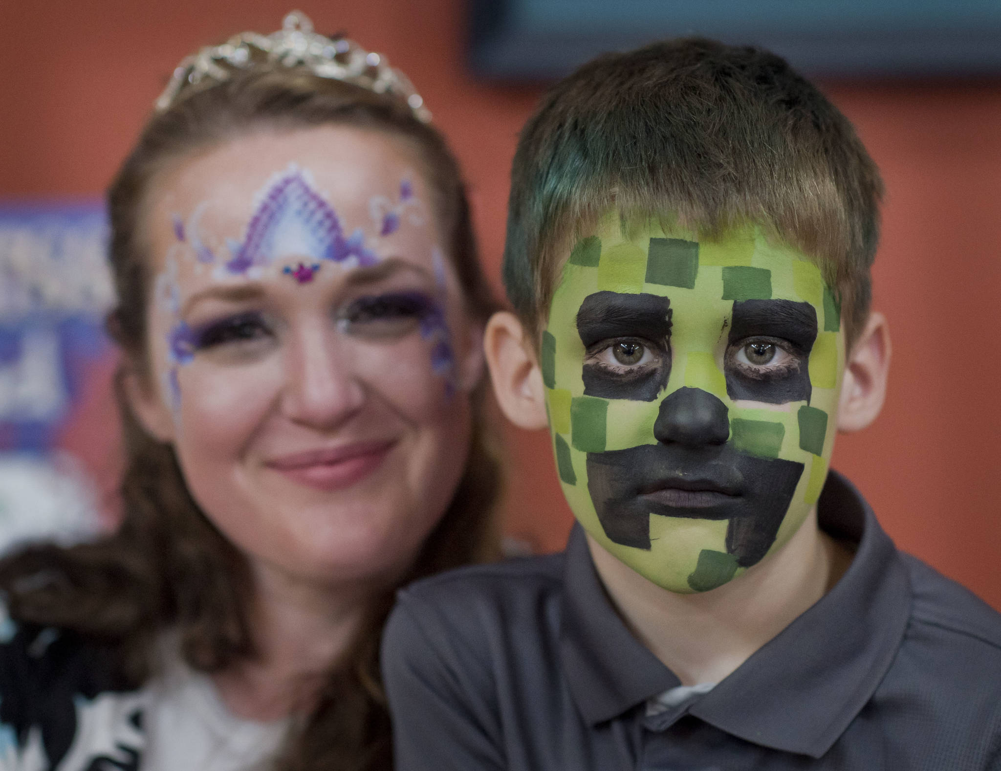Jessica Snyder, of Sunny Days Body Art, poses with her son, Crispin, during the Block Party at the Juneau Arts & Culture Center on Friday, June 15, 2018. (Michael Penn | Juneau Empire)