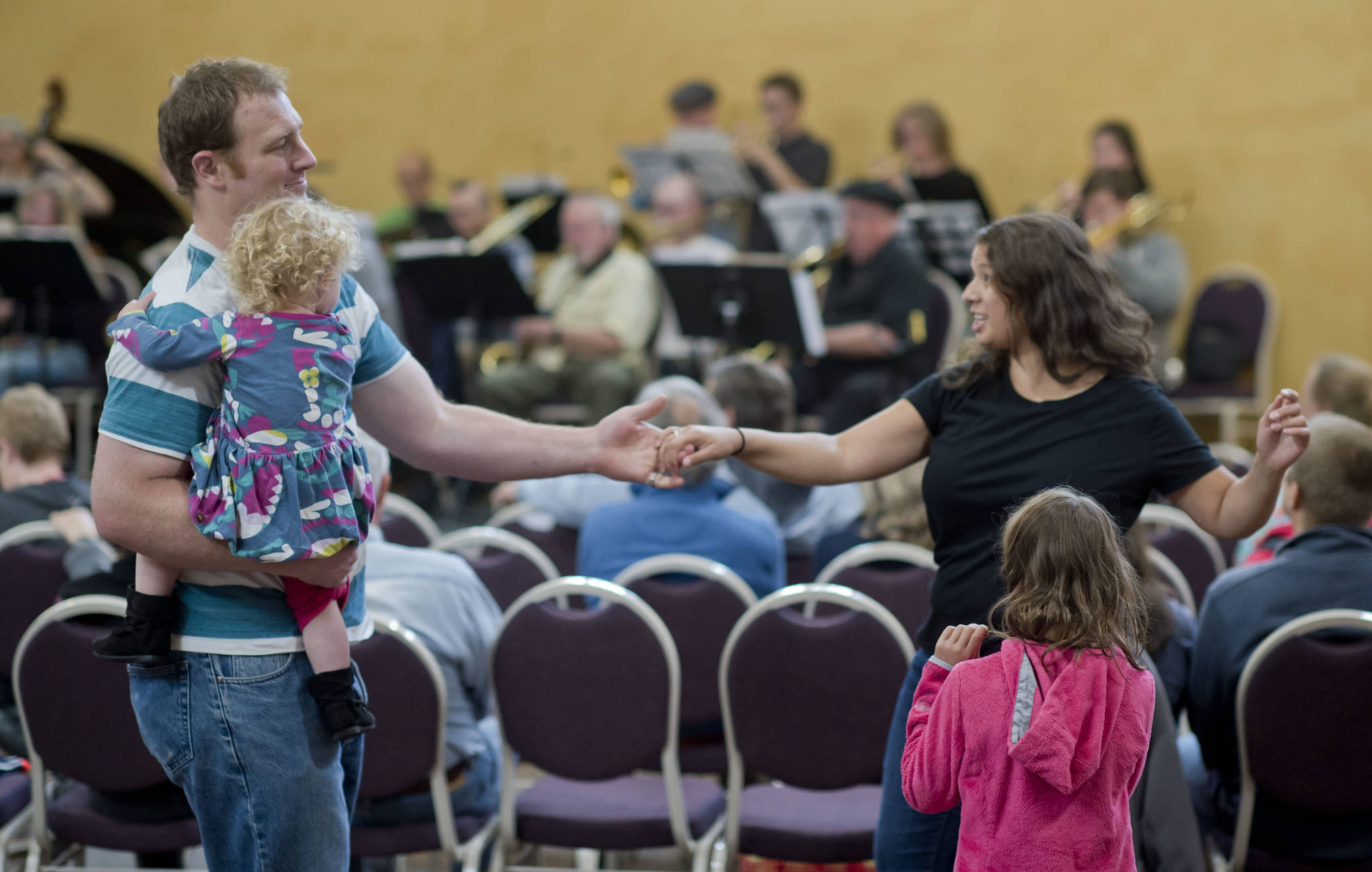 Emily Lockie dances with her husband, Scott, and their children, Eava and Annalise, during the Block Party at the Juneau Arts & Culture Center on Friday, June 15, 2018. (Michael Penn | Juneau Empire)