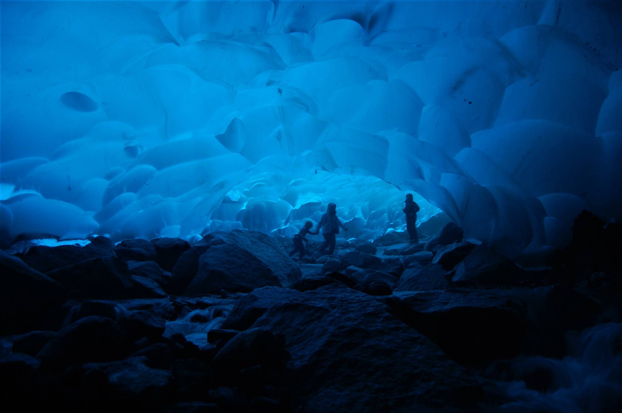 Three intrepid adventurers exploring an ice cave on Mendenhall Glacier in 2012.