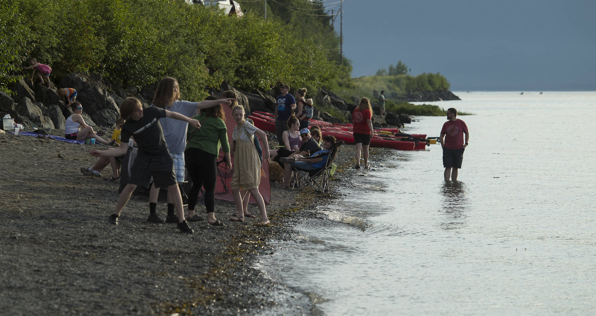 Juneau residents listen to the music of Papertrail and enjoy the beach during a solstice party at the North Douglas Boat Launch on Wednesday, June 20, 2018. (Michael Penn | Juneau Empire)