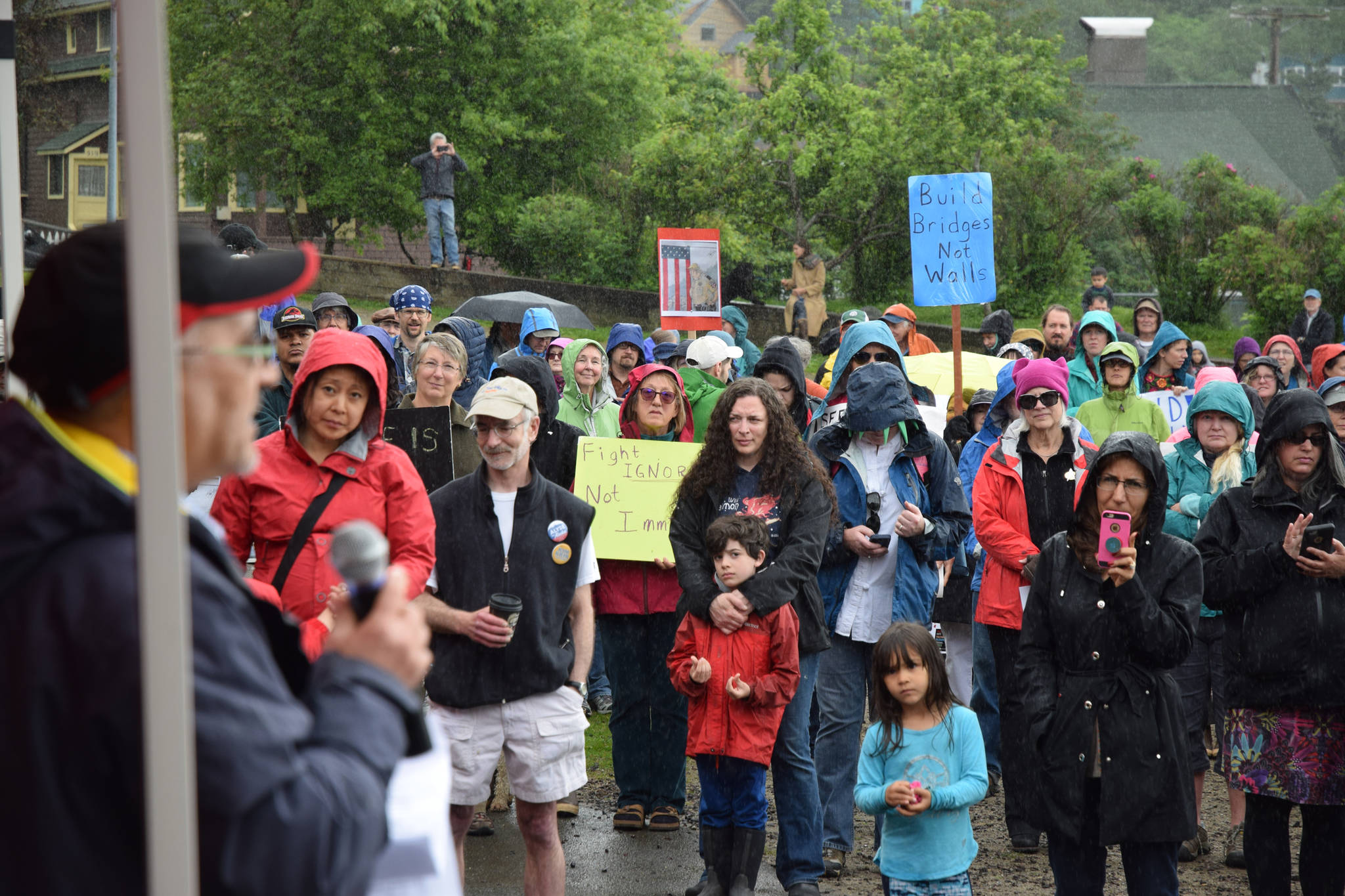 Mansour Sadeghi speaks to a crowd of protestors Saturday at Capital Park during a rally against family separation at the U.S. southern border. (Kevin Gullufsen | Juneau Empire)