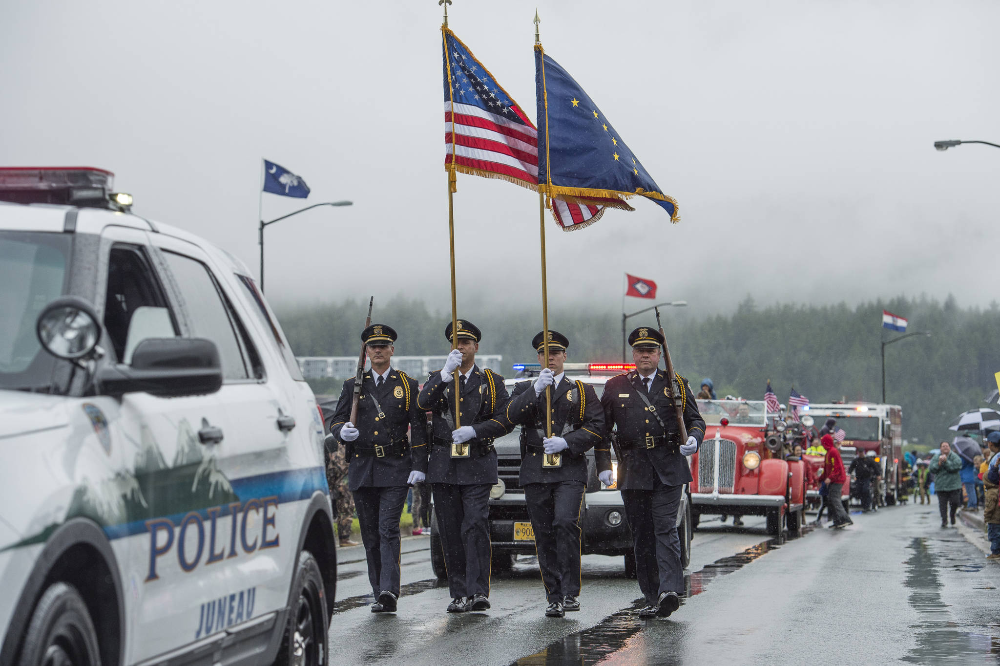 Juneau Police Department representatives march in the Juneau 4th of July parade on Tuesday, July 4, 2017. (Michael Penn | Juneau Empire File)