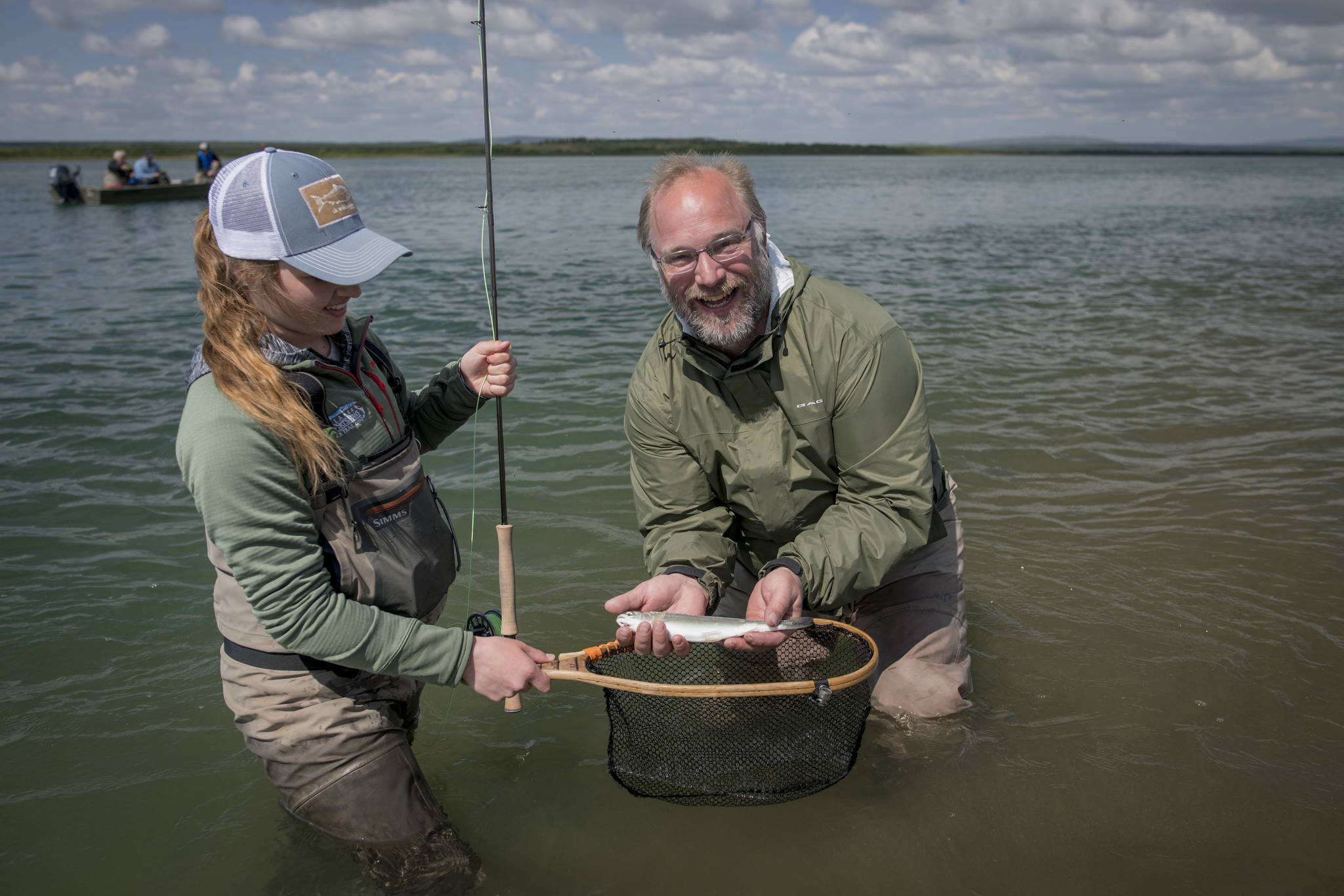 Abbey Whitcomb and her client, Naknek resident Bryon Singly, pose with a small rainbow on the Naknek River. (Courtesy Photo | Sarah Miller)