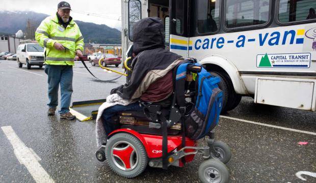In this file photo from November 2014, a Care-A-Van driver picks up a person with a wheelchair at Centennial Hall parking lot. (Michael Penn | Juneau Empire File)