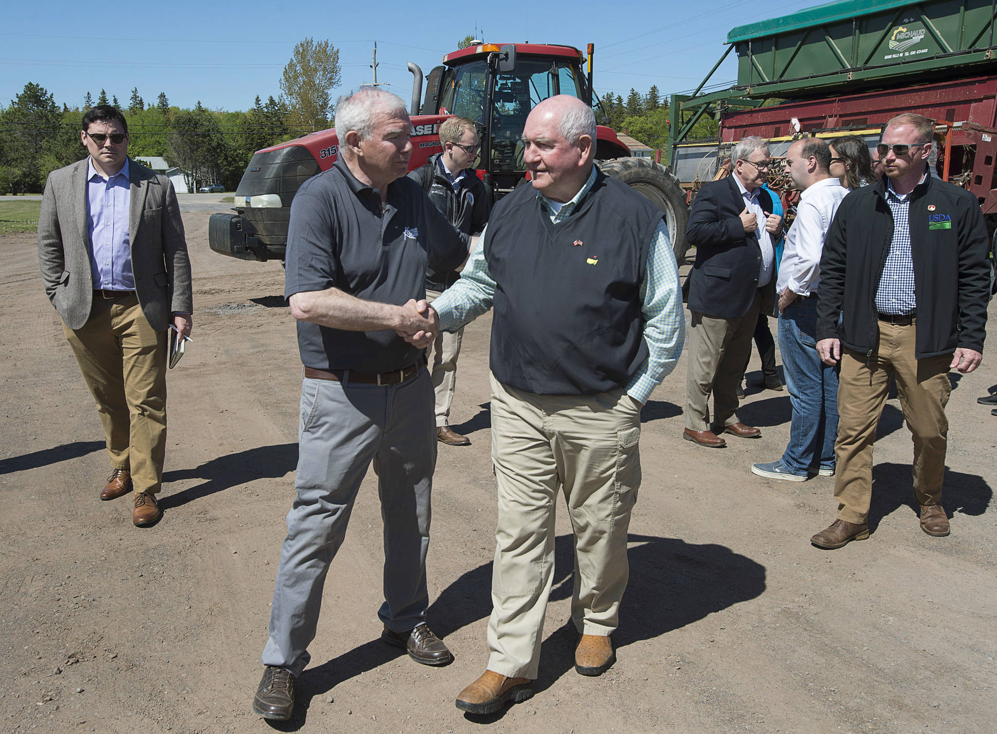 U.S. Secretary of Agriculture Sonny Perdue, right, shakes hands with owner Ray Keenan after touring Rollo Bay Holdings, which specializes in potato producing, marketing, shipping and exporting, in Souris, Prince Edward Island, Canada, on Friday, June 15, 2018. (Andrew Vaughan/The Canadian Press via AP)