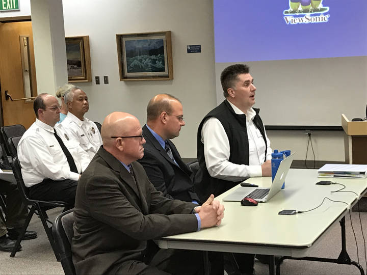 Fitch and Associates members Steve Knight and BJ Jungman make a presentation along with Capital City and Fire Rescue Fire Chief Steve Etheridge during the City and Borough of Juneau Committee of the Whole meeting Wednesday. (Gregory Philson| Juneau Empire)