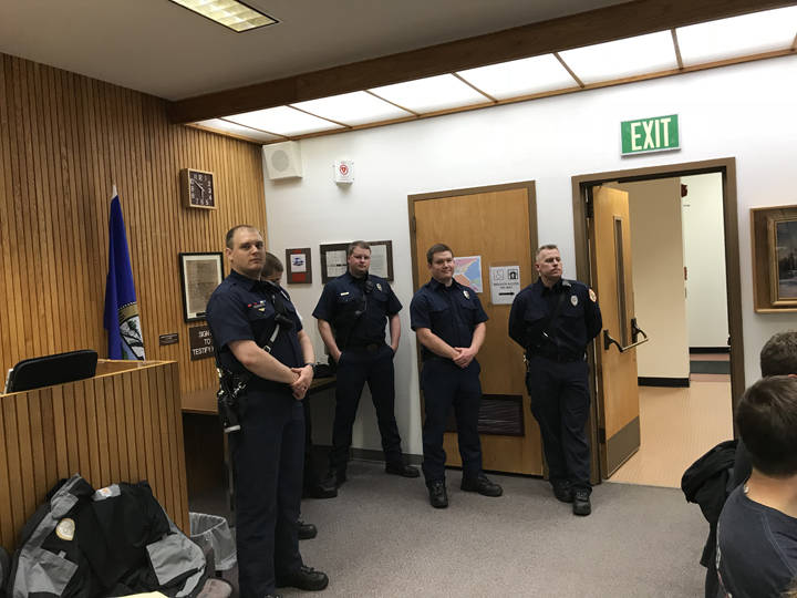 Members of the Capital City Fire and Rescue squad watch on during a presentation about staffing for the department at the Committee of the Whole meeting Wednesday. (Gregory Philson | Juneau Empire)