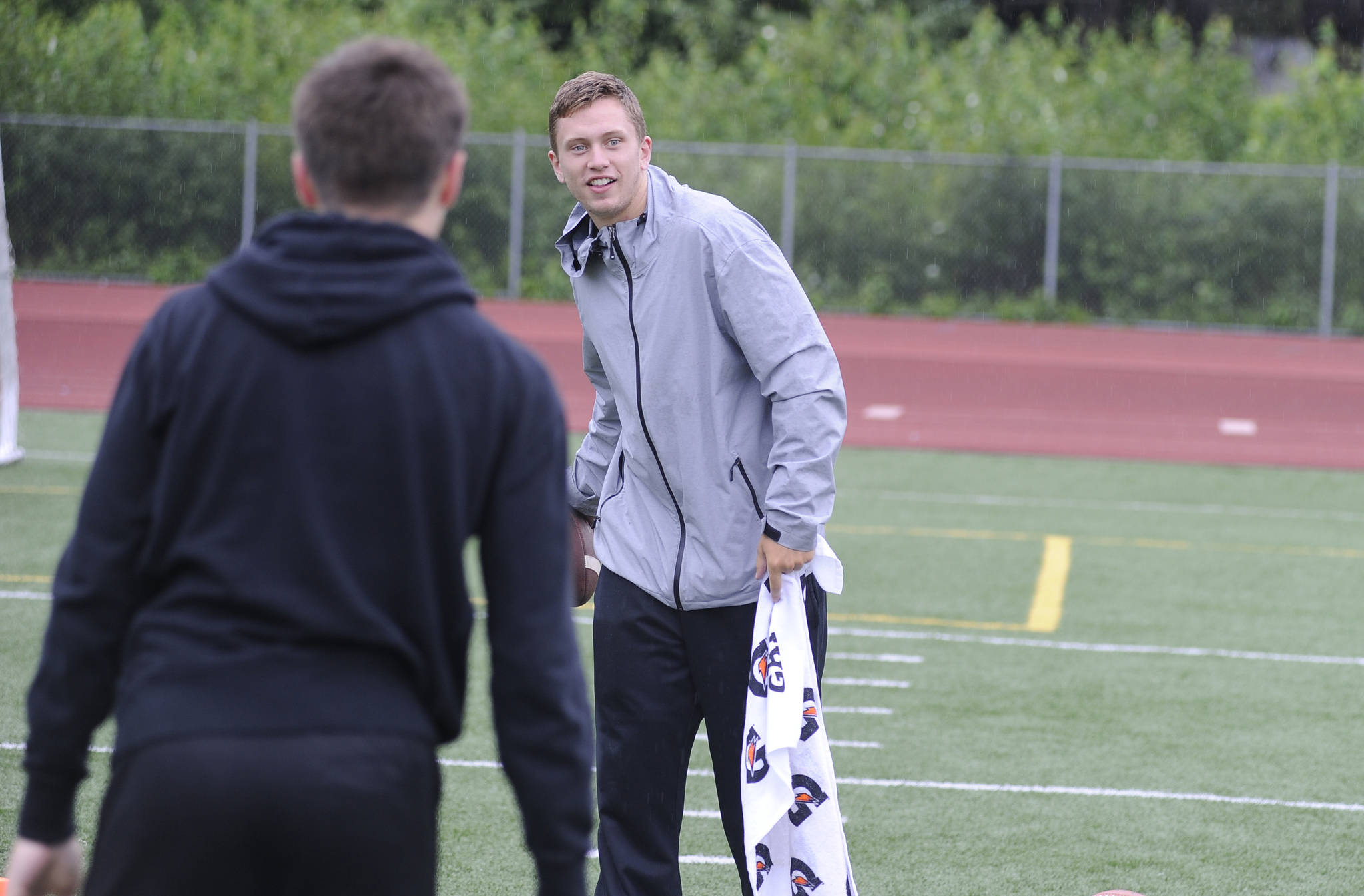 Western Oregon University quarterback Ty Currie tosses the ball to a camper during the Football Skills, Strength and Speed Camp at Thunder Mountain High School on Wednesday. Currie is one of three active WOU players helping to staff the camp this week. (Nolin Ainsworth | Juneau Empire)