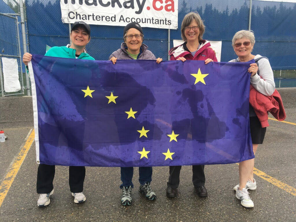 Lauren Smoker, Susan Haymes, Ann Sutton and Beatrice Franklin show off the Alaska flag at last year’s Capital Cup between the Juneau and Whitehorse tennis communities. Smoker, Haymes and Franklin are members of this year’s Juneau team. (Courtesy Photo | Mona Mametsuka)