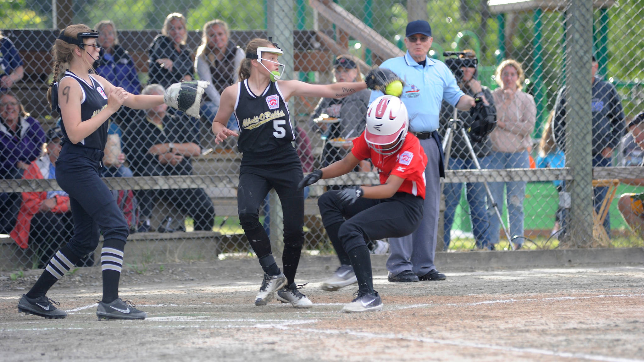 Gastineau Channel Little League’s Remi Starks steals home under the glove of Abbott-O-Rabbit Little League’s Alexis Moore in the top of the fourth inning of the Alaska Major Softball State Championships at Melvin Park on Thursday. GCLL (Juneau) won 16-13. (Nolin Ainsworth | Juneau Empire)