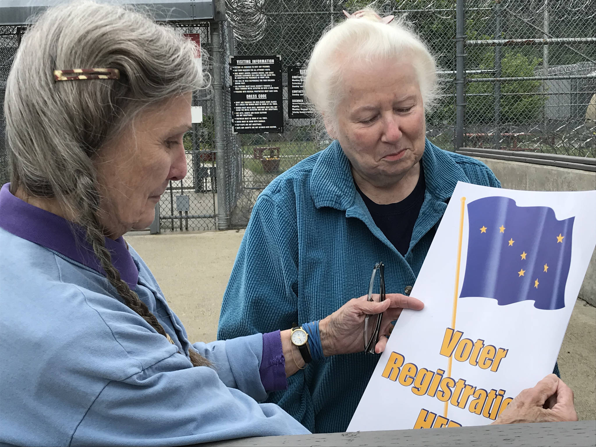 In this photo provided by the Alaska Division of Elections, Carolyn Brown (left) and Judy Andree of the Juneau Chapter of the League of Women Voters examine materials before visiting Lemon Creek Correctional Center on July 10, 2018. The division and league have begun a pilot program to allow eligible Alaska inmates to register to vote and seek absentee ballots. (Samantha Miller | Courtesy Photo)