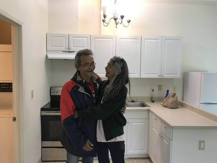 Clyde Didrickson and his wife, Charlotte, smile and hug each other in their new home Friday morning. The couple were able to get their new home through a Tlingit Haida Regional Housing Authority grant funding program aimed to help veterans. (Gregory Philson | Juneau Empire)