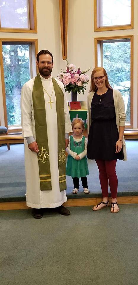 Pastor Cale Mead, left, was installed as the new pastor at Christ Lutheran Church in Juneau this week. His daughter Amelia and wife Lauren pose for a picture by his side. (Photo courtesy Lynda Barker)