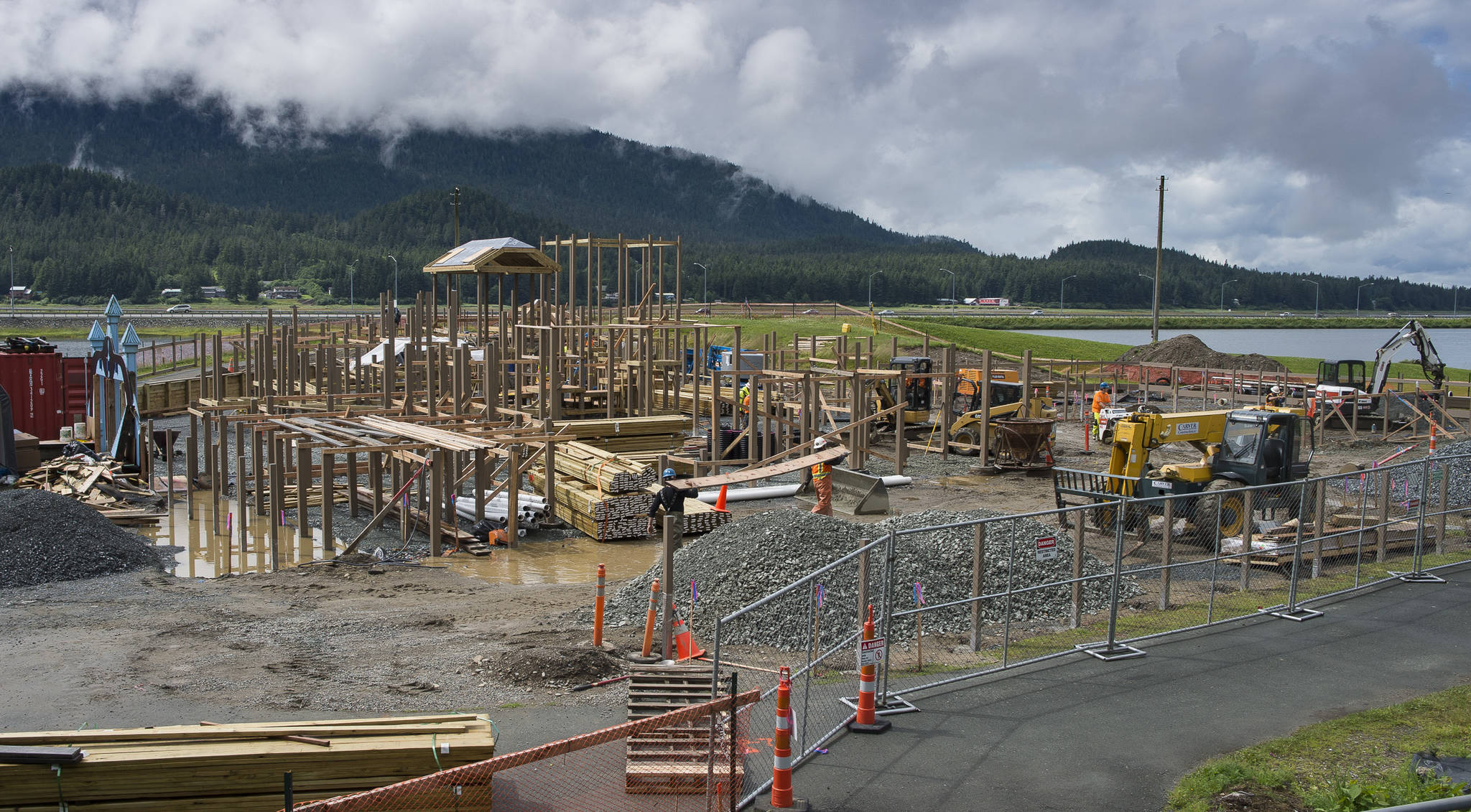 Construction crews continue the rebuilding of Project Playground at Twin Lakes on Monday, July 16, 2018. The Community portion of the build will be August 8 – 12, 2018. Built in 2007, the playground burned down in 2017. (Michael Penn | Juneau Empire)
