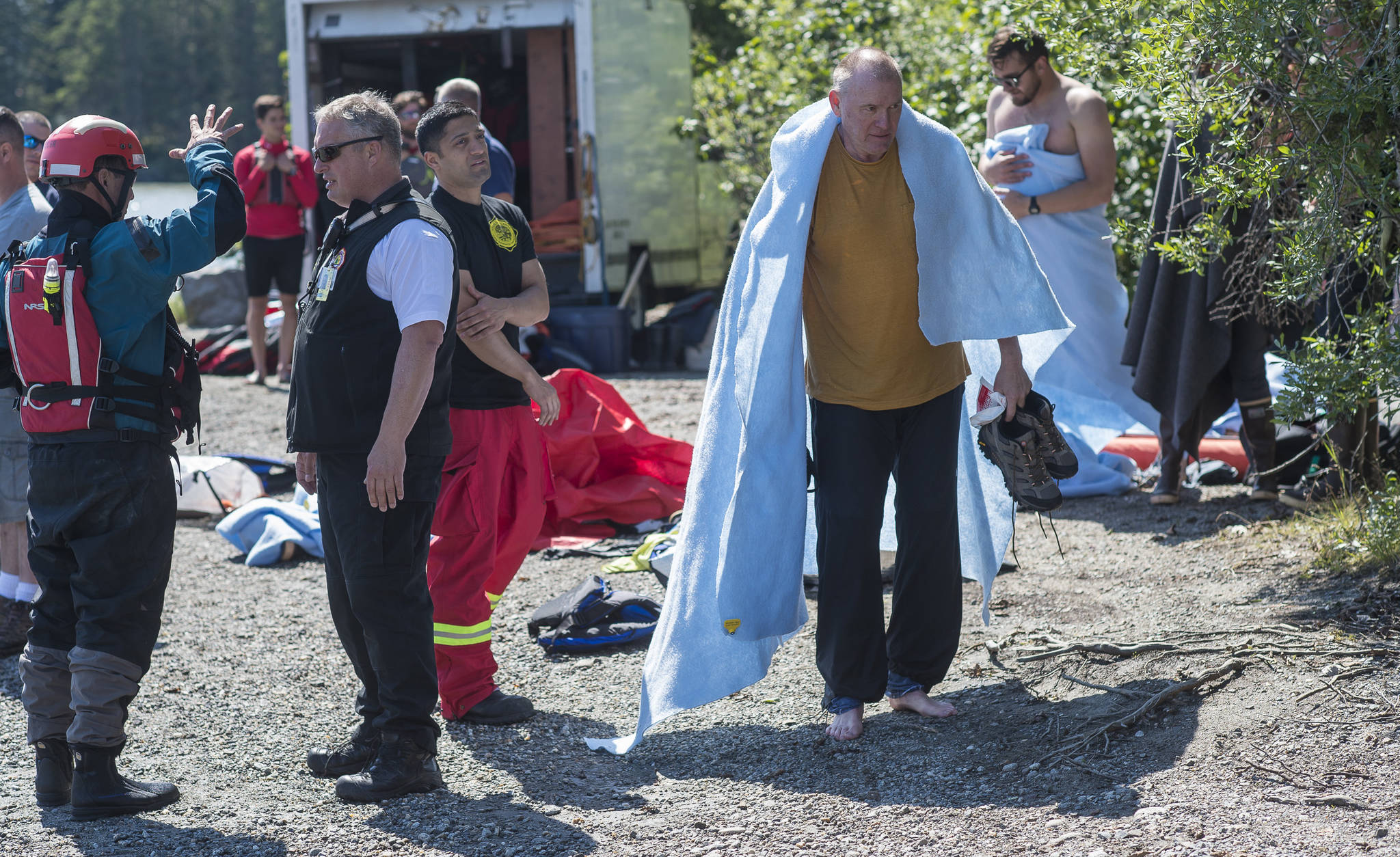 Capital City Fire/Rescue personnel care for victims who overturned their canoe during a guided trip on Mendenhall Lake on Friday, July 20, 2018. (Michael Penn | Juneau Empire)