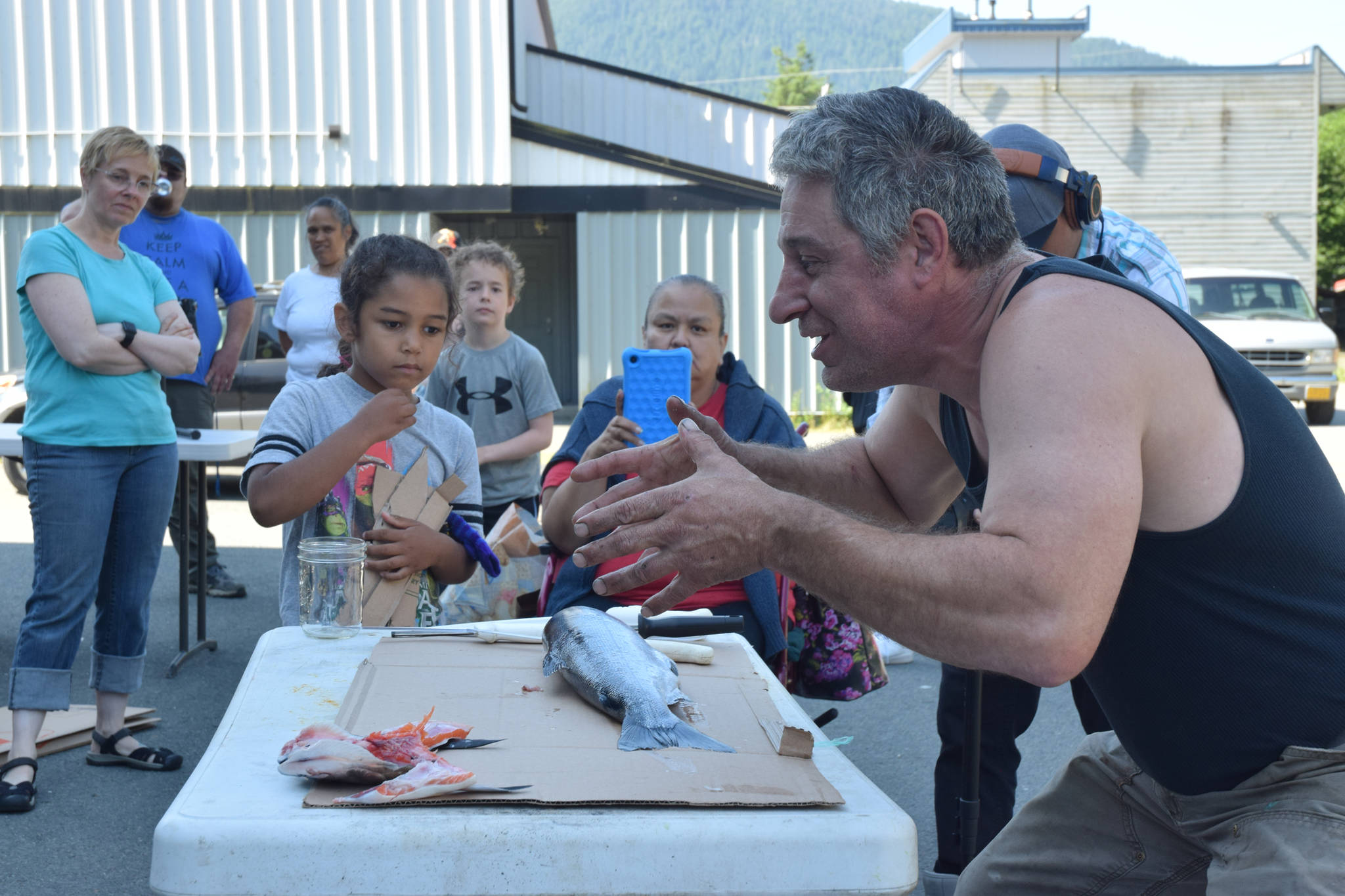 Cultural specialist John Smith tells stories about salmon while processing fish during a salmon preservation workshop on Saturday, July 21, 2018. (Kevin Gullufsen | Juneau Empire)