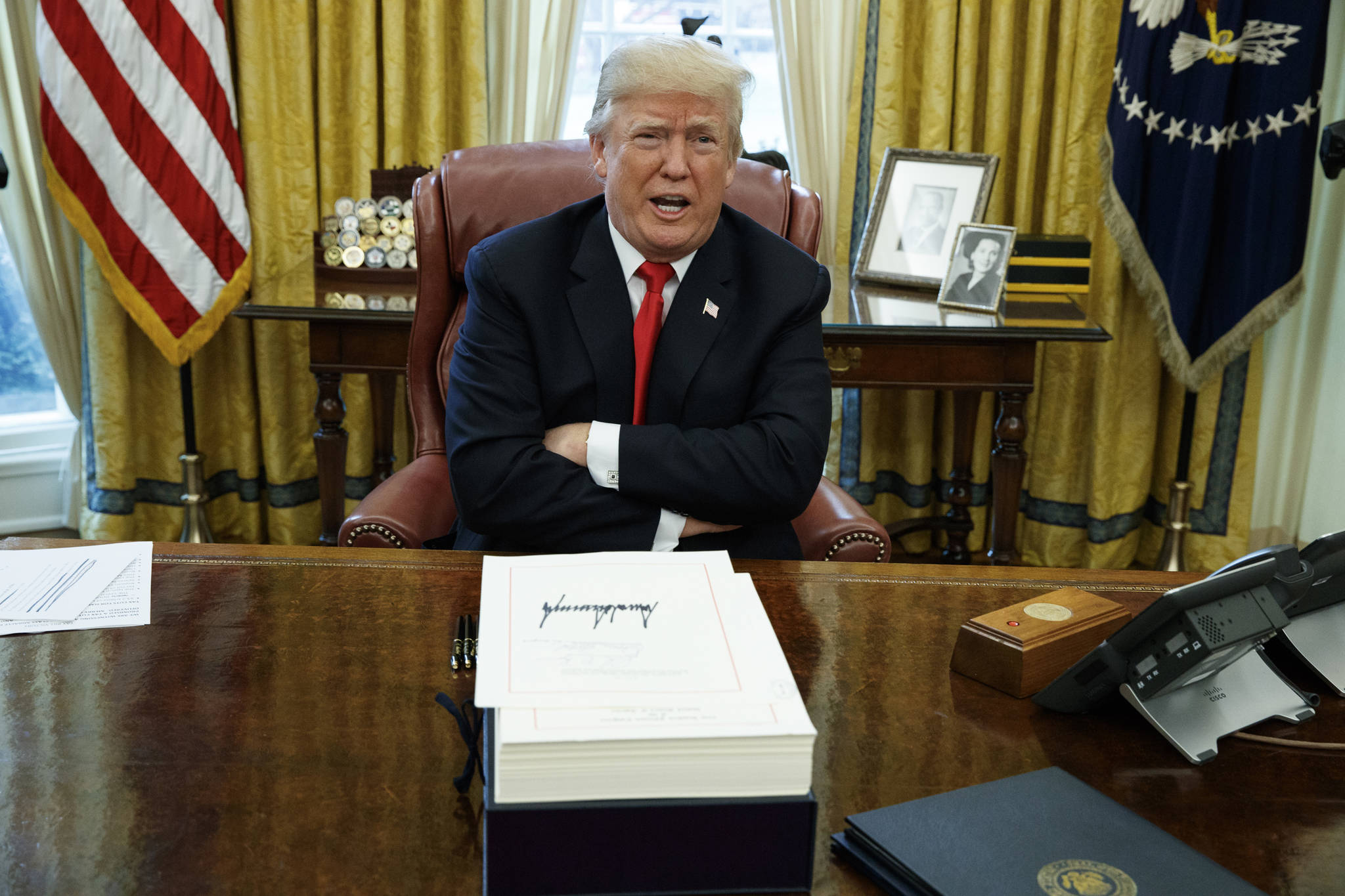 In this Dec. 22, 2017, file photo, President Donald Trump speaks with reporters after signing the tax bill and continuing resolution to fund the government, in the Oval Office of the White House in Washington. On Friday, the president signed two bills by Rep. Don Young, R-Alaska. (AP Photo/Evan Vucci, File)