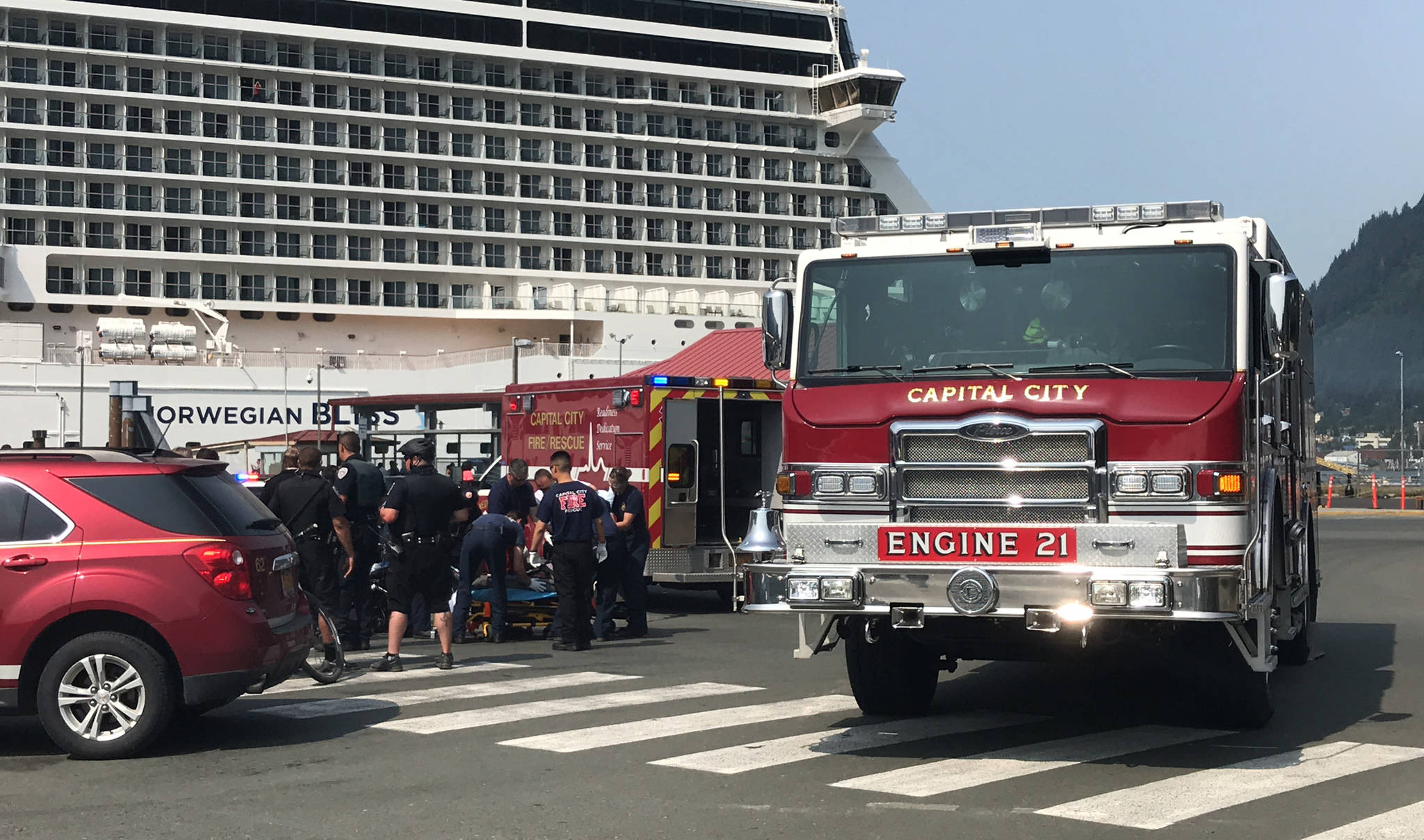Capital City Fire/Rescue responders prepare to load a man into an ambulance after he was hit by a bus at the AJ Dock on Tuesday, July 24, 2018. The man’s injuries were minor and he was set to be released from the hospital later in the day. (Alex McCarthy | Juneau Empire)