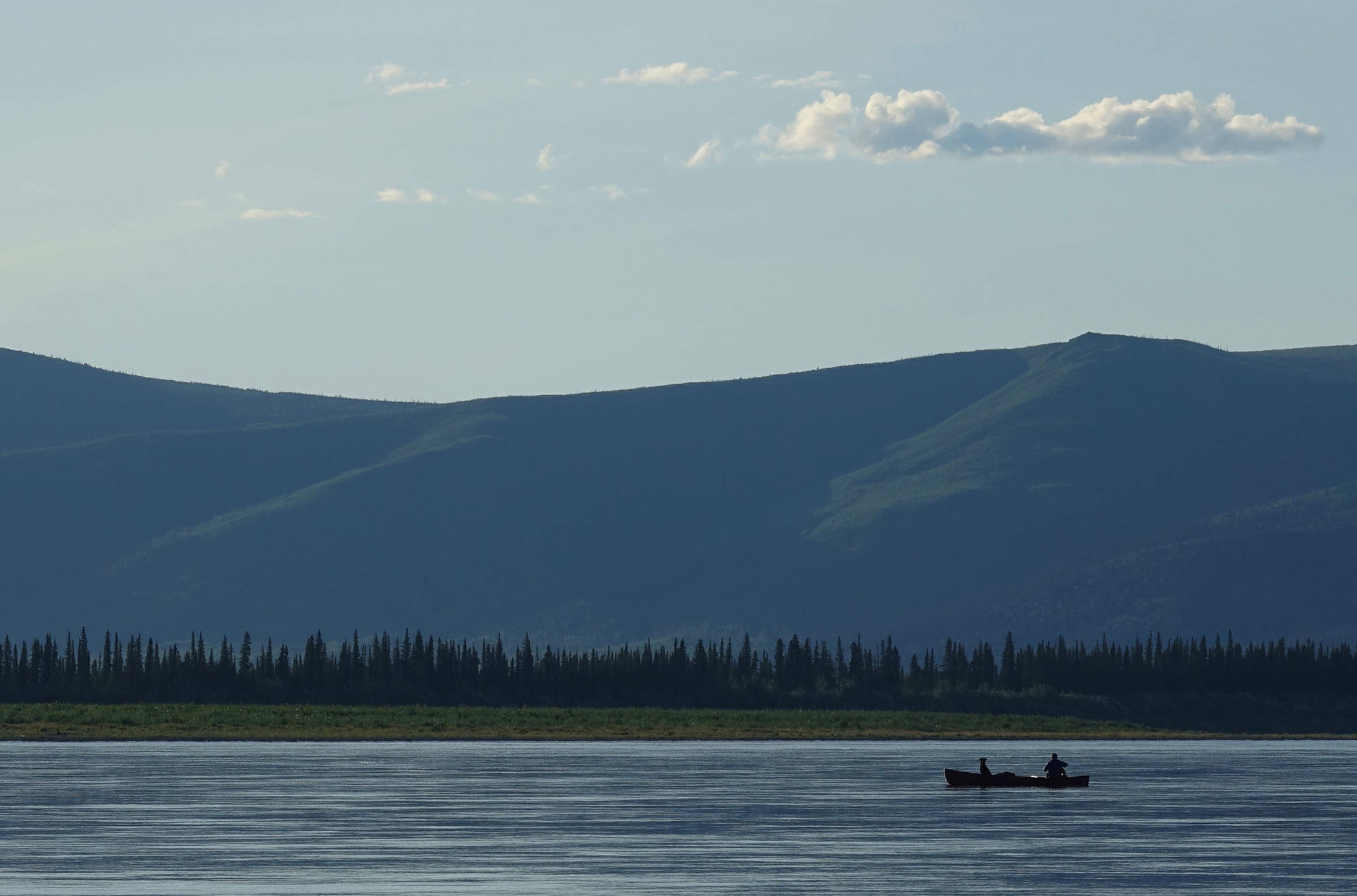 Cora the dog and Ned Rozell float down the Yukon River just upstream from Circle. (Photo by Skip Ambrose)