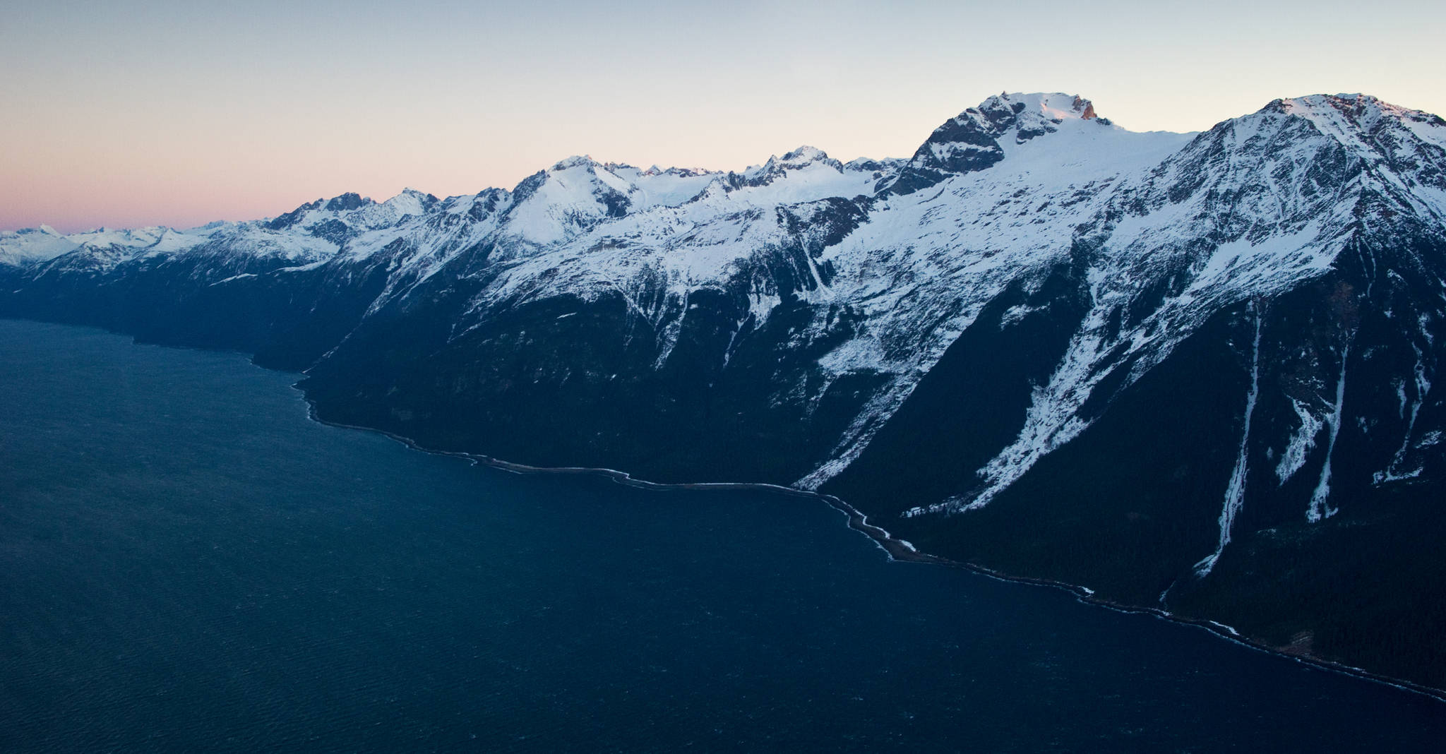 A road north of Juneau would have to negotiate the steep terrain of the east side of Lynn Canal, pictured here in a February 2014 Juneau Empire file photo. (Michael Penn | Juneau Empire)