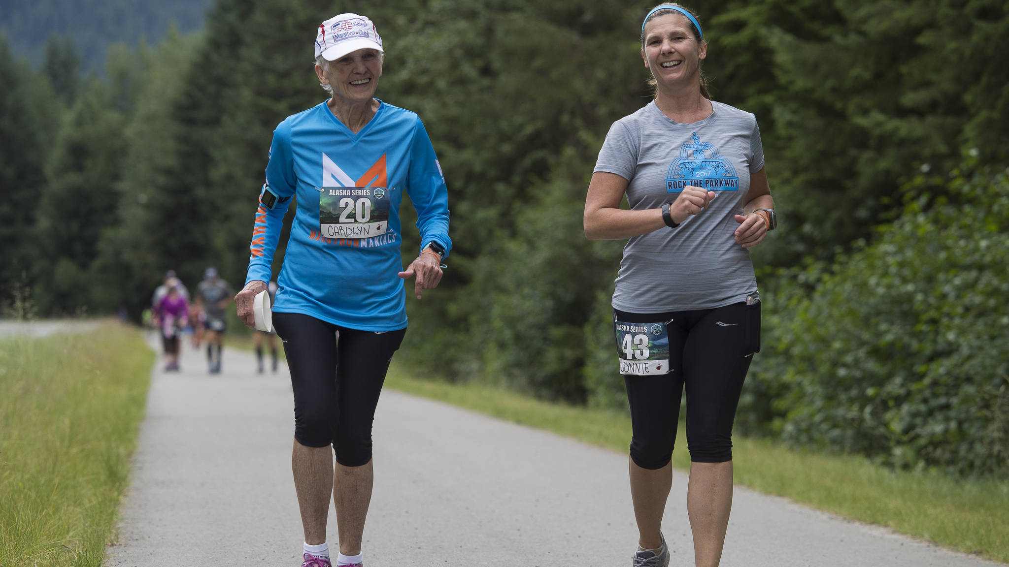 Carolyn Mitchell runs with her daughter, Connie Deverill, in a marathon coordinated by Mainly Marathons along Mendenhall Loop Road on Thursday, July 26, 2018. For Mitchell, 81, it was her 175th marathon. (Michael Penn | Juneau Empire)