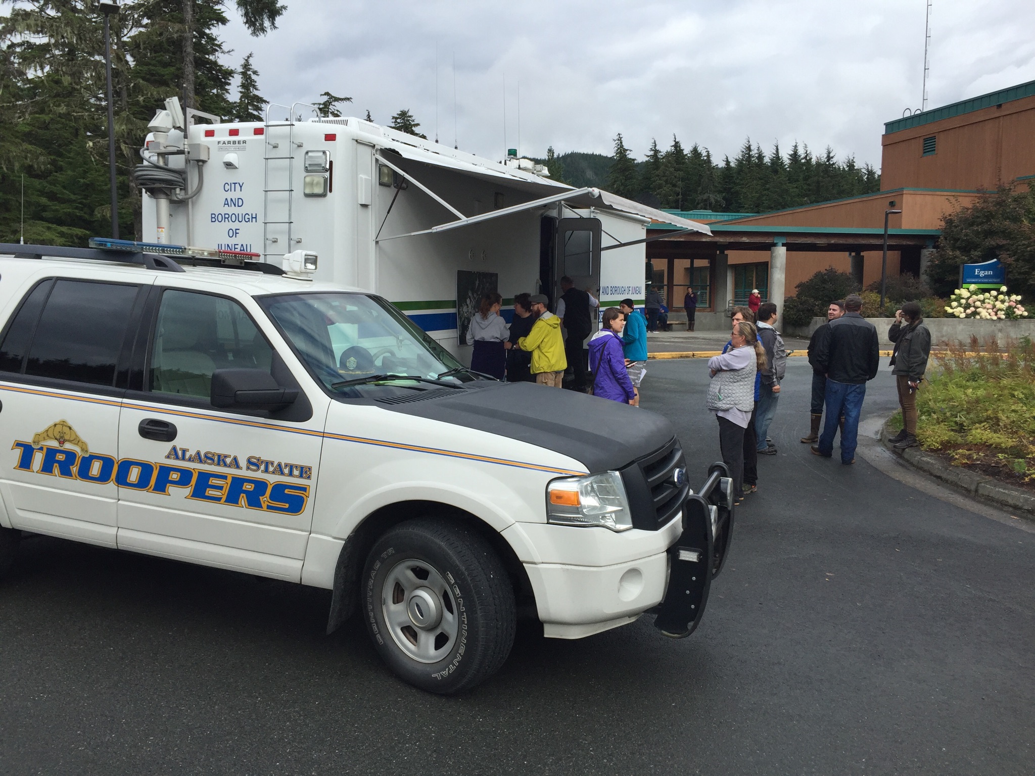 Searchers gather at the Juneau Police Department Mobile Command Center at UAS in the search of Ryan Harvey on Thursday.