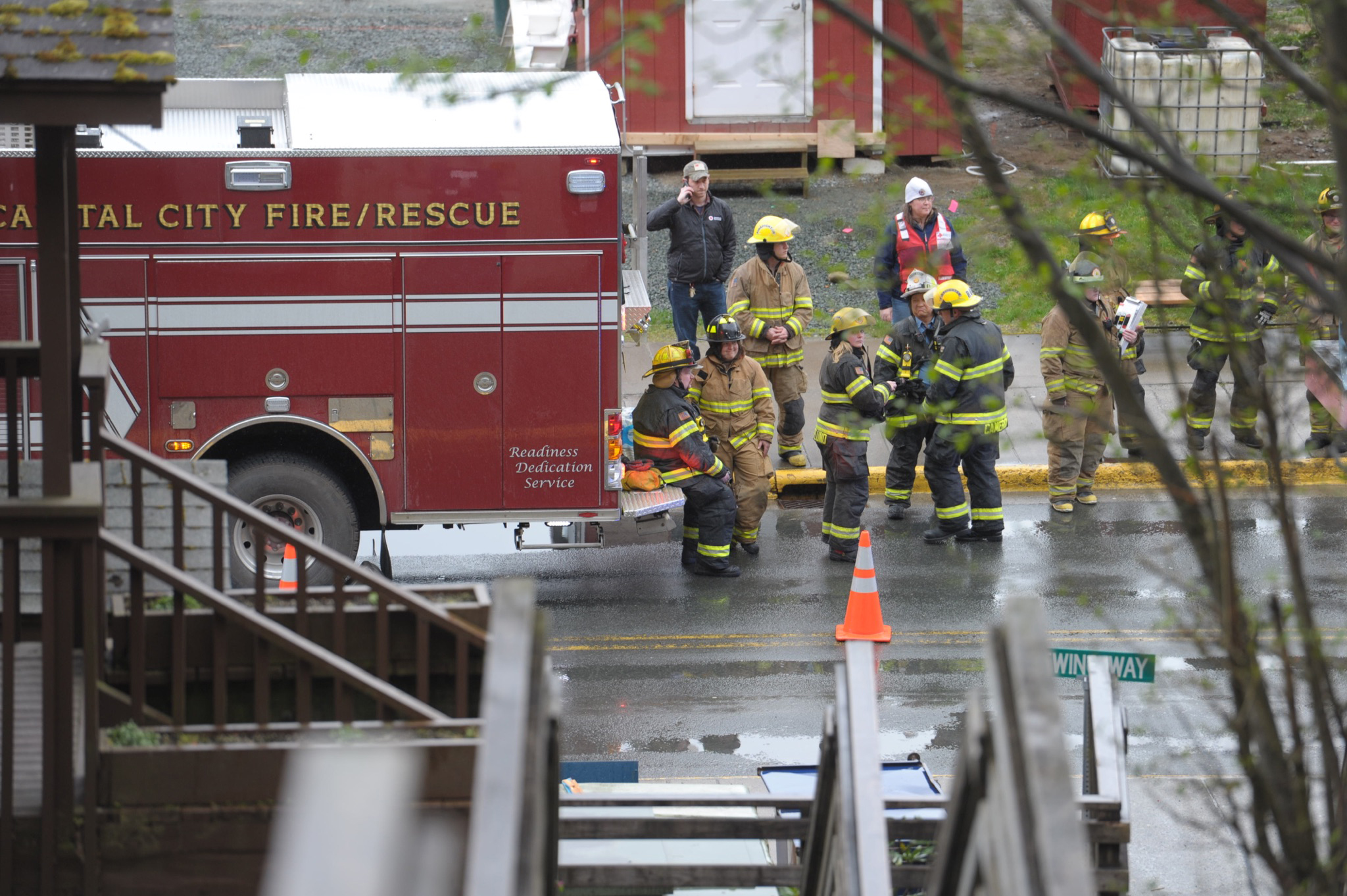 Firemen wait on Franklin Street after responding to a fire at the Channel View Apartments on Sunday.