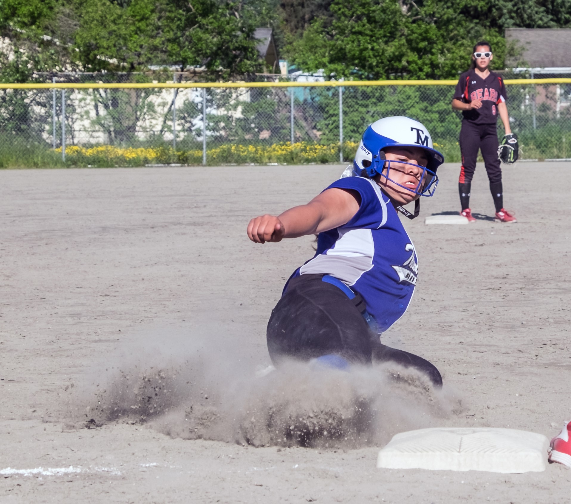 Thunder Mountain's Nina Fenumiai (4) slides into third base during a Saturday game against Juneau-Douglas High School. TMHS won 7-4.
