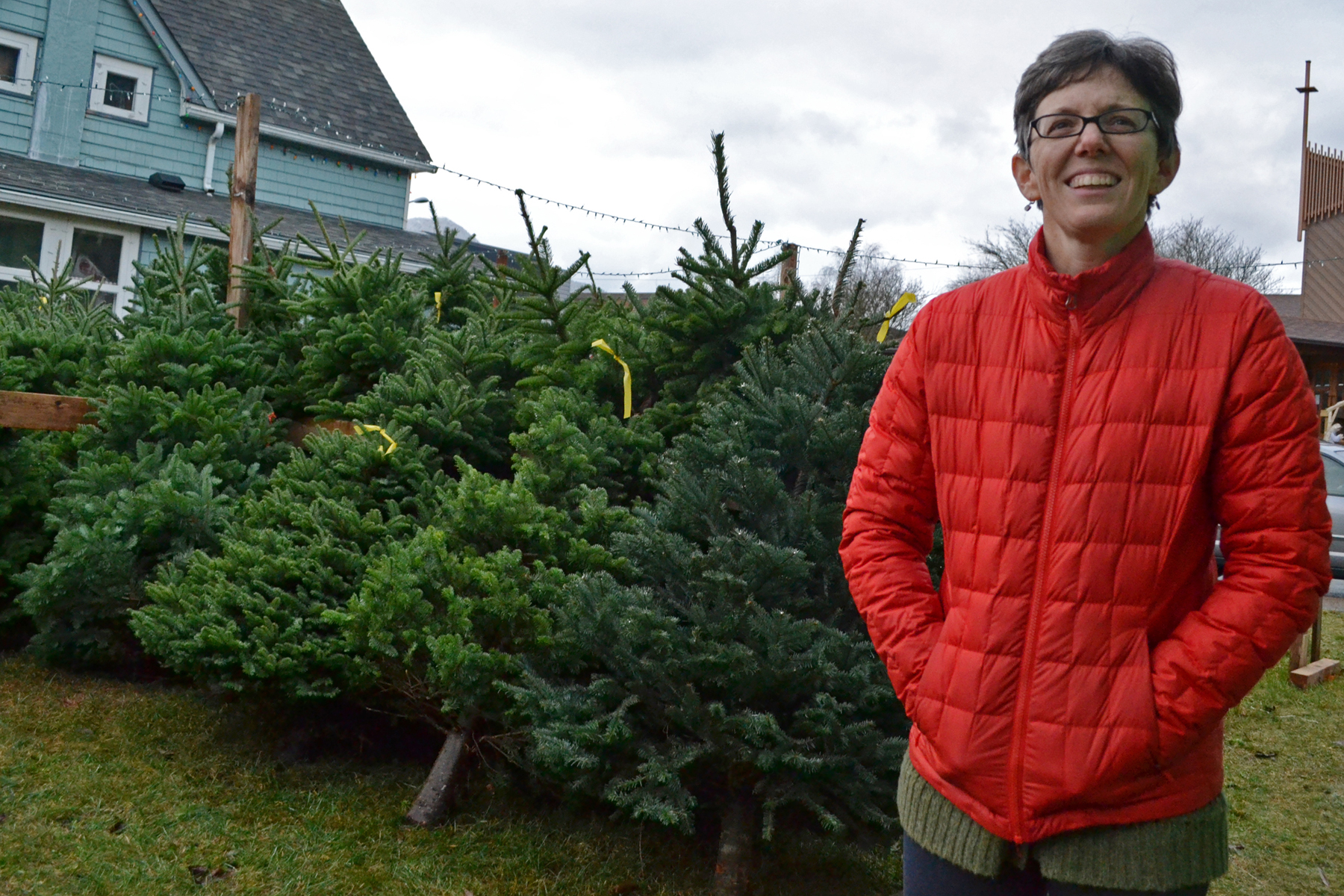 Kim Champney stands outside of her home in the Flats, where her children run a Christmas tree business each year. Champney and her kids received a shipment of 200 trees from Orting, Washington, late last week. They plan to donate $5 from each tree sale to Juneau's Housing First Project.