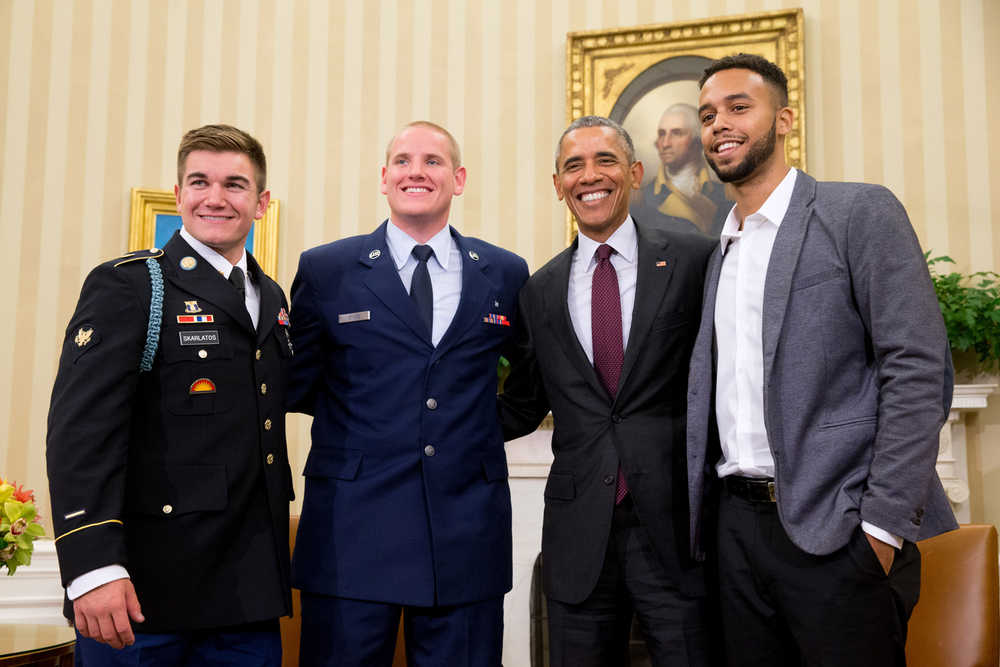 CORRECTS TO PARIS-BOUND TRAIN - President Barack Obama poses for a photograph with Oregon National Guardsman, from left, Alek Skarlatos Air Force Airman 1st Class Spencer Stone, and Anthony Sadler, in the Oval Office of the White House in Washington, Thursday, Sept. 17, 2015, to honor them for heroically subduing a gunman on a Paris-bound passenger train last month. (AP Photo/Andrew Harnik)