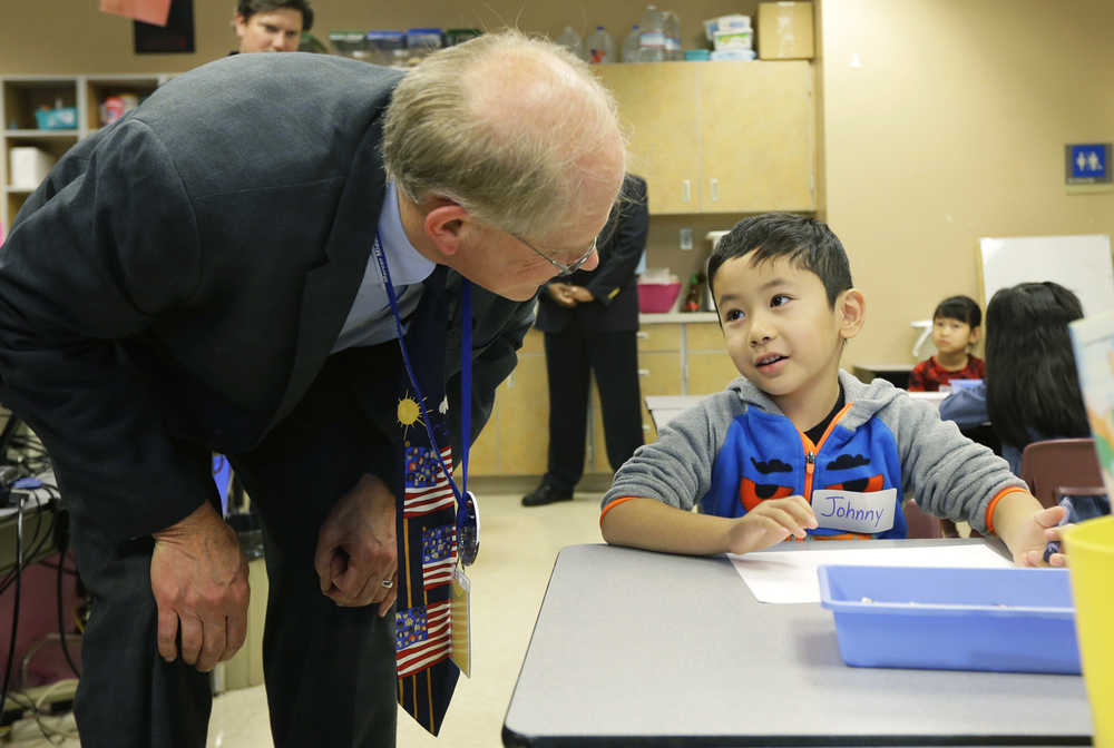 Seattle Schools Superintendent Larry Nyland, left, talks with Johnny Hoang, 5, on his first day of kindergarten at Concord International School, Thursday, Sept. 17, 2015, in Seattle. Nyland was visiting the school Thursday on the first day for students in the Seattle School District to begin classes for the new school year following a weeklong teachers strike. (AP Photo/Ted S. Warren)