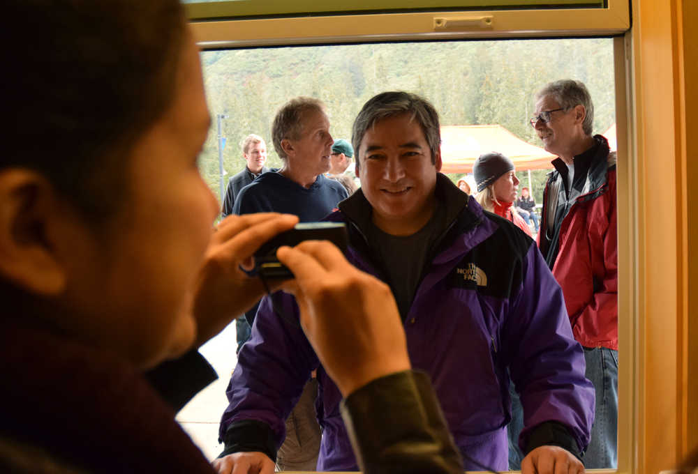 Rep. Sam Kito III, D-Juneau, smiles as he has his picture taken for his ski pass ID at the grand opening of the Porcupine Lodge on Saturday, Sept. 19, 2015 at Eaglecrest Ski Area.