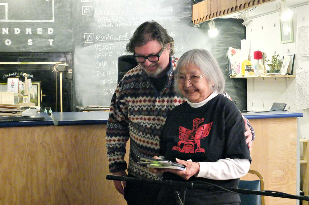 Visiting NYC poet Bob Holman helps Juneau poet Nora Marks Dauenhauer back to her seat after her reading at Kindred Post Saturday.