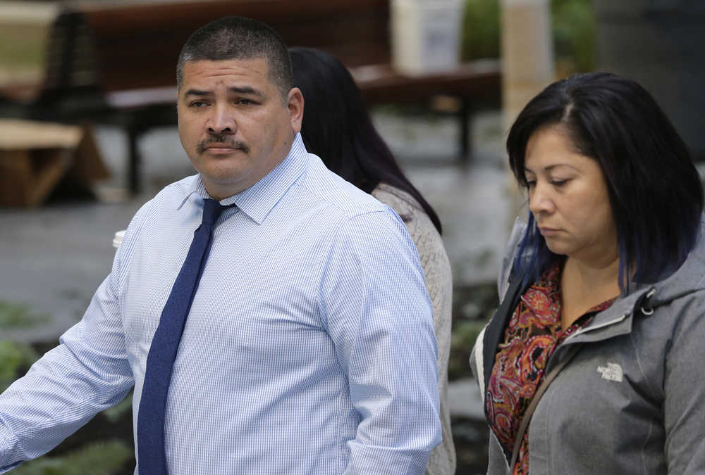 Raymond Fryberg, left, the father of the Washington state teenager who fatally shot four classmates and himself at Marysville-Pilchuck High School in October 2014, arrives at the federal courthouse in Seattle, Monday, Sept. 21, 2015. Fryberg is on trial this week for six counts of illegally possessing firearms, including the one used in the shooting, while under a domestic violence restraining order that meant he was not allowed to have guns. (AP Photo/Ted S. Warren)