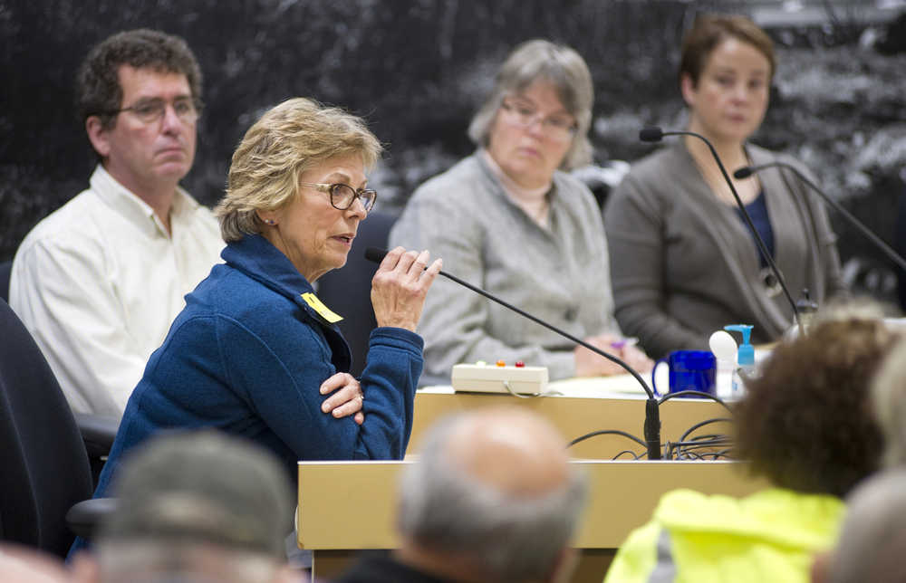 Catherine Gitkov speaks against the ordinance to eliminate the senior tax exemption at the Juneau Assembly meeting on Monday. City staff in the background are Deputy City Manager Rob Steedle, left, City Manager Kim Kiefer, center, and City Attorney Amy Mead.