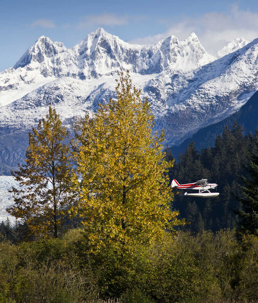 A floatplane takes off from the Juneau International Airport as fall colors give way to snow on the Mendenhall Towers on Tuesday.