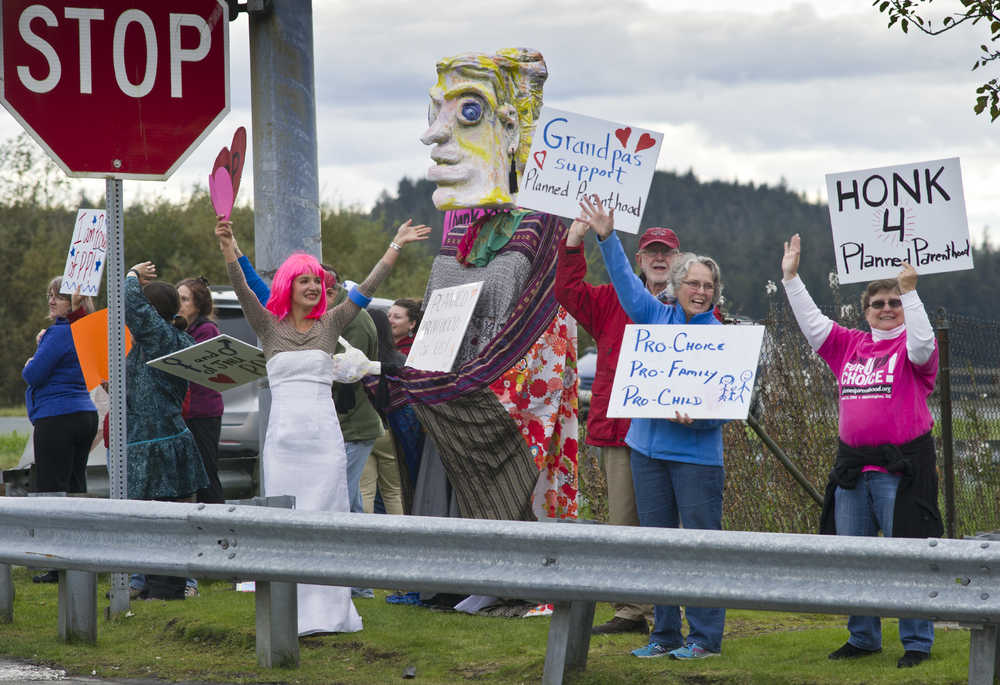 Juneau residents rally for Planned Parenthood at the corner of Egan and Channel Drives on Wednesday.