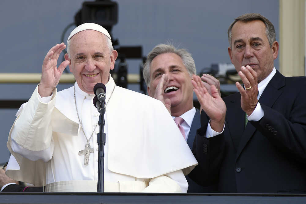 House Speaker John Boehner of Ohio becomes emotional as Pope Francis appears on the Speaker's Balcony on Capitol Hill, Thursday, Sept. 24, 2015 and waves to the waiting crowd below on the Capitol grounds. The pope addressed a joint meeting of Congress before stepping out on the balcony. Between the pope and Boehner is Majority Leader Kevin McCarthy of California. (AP Photo/Susan Walsh)