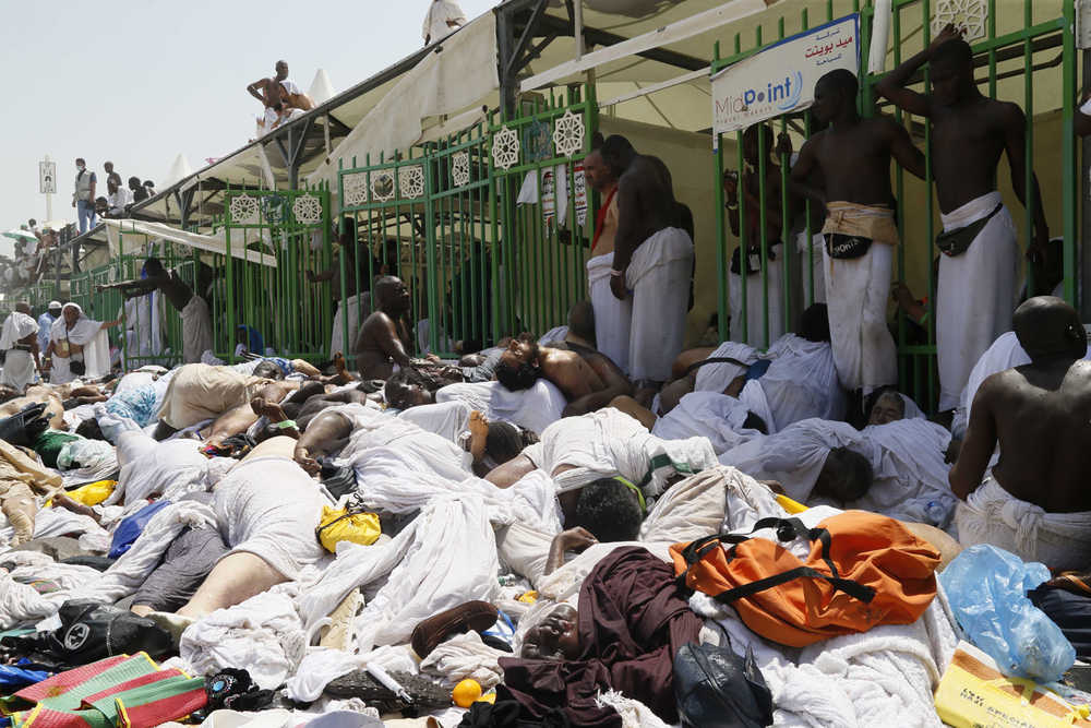 Muslim pilgrims gather around bodies of people crushed in Mina, Saudi Arabia during the annual hajj pilgrimage on Thursday, Sept. 24, 2015. Hundreds were killed and injured, Saudi authorities said. The crush happened in Mina, a large valley about five kilometers (three miles) from the holy city of Mecca that has been the site of hajj stampedes in years past. (AP Photo)