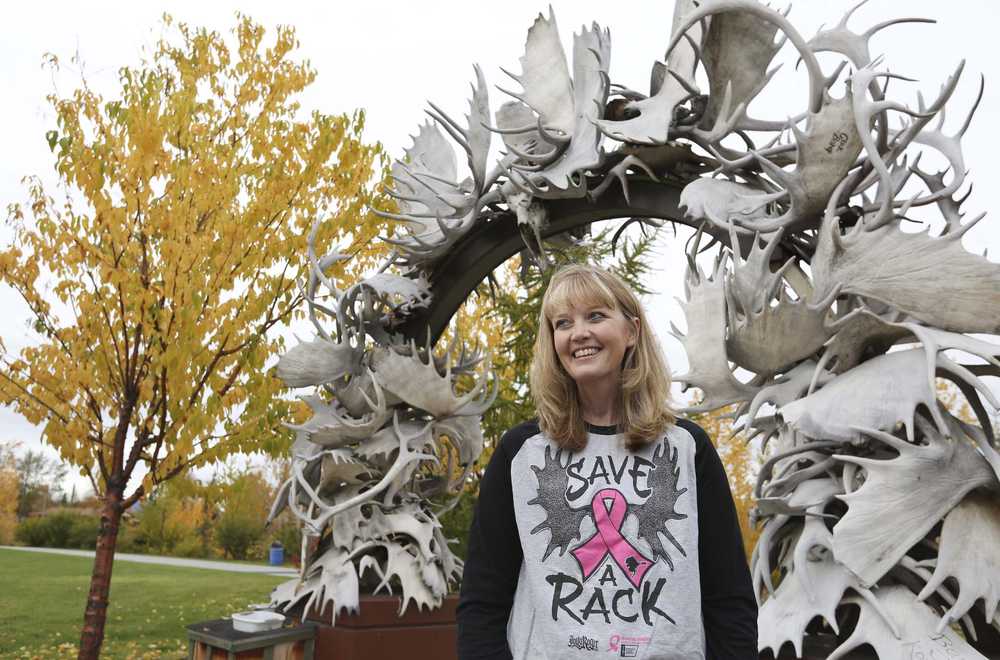 Becky Zaverl, a three-time cancer survivor, poses below the Antler Arch near the Morris Thompson Cultural and Visitors Center in Fairbanks on Sept. 18. Zaverl, a three time cancer survivor, is the driving force behind the Fairbanks Making Strides Against Breast Cancer 5K family walk, a fundraising event.