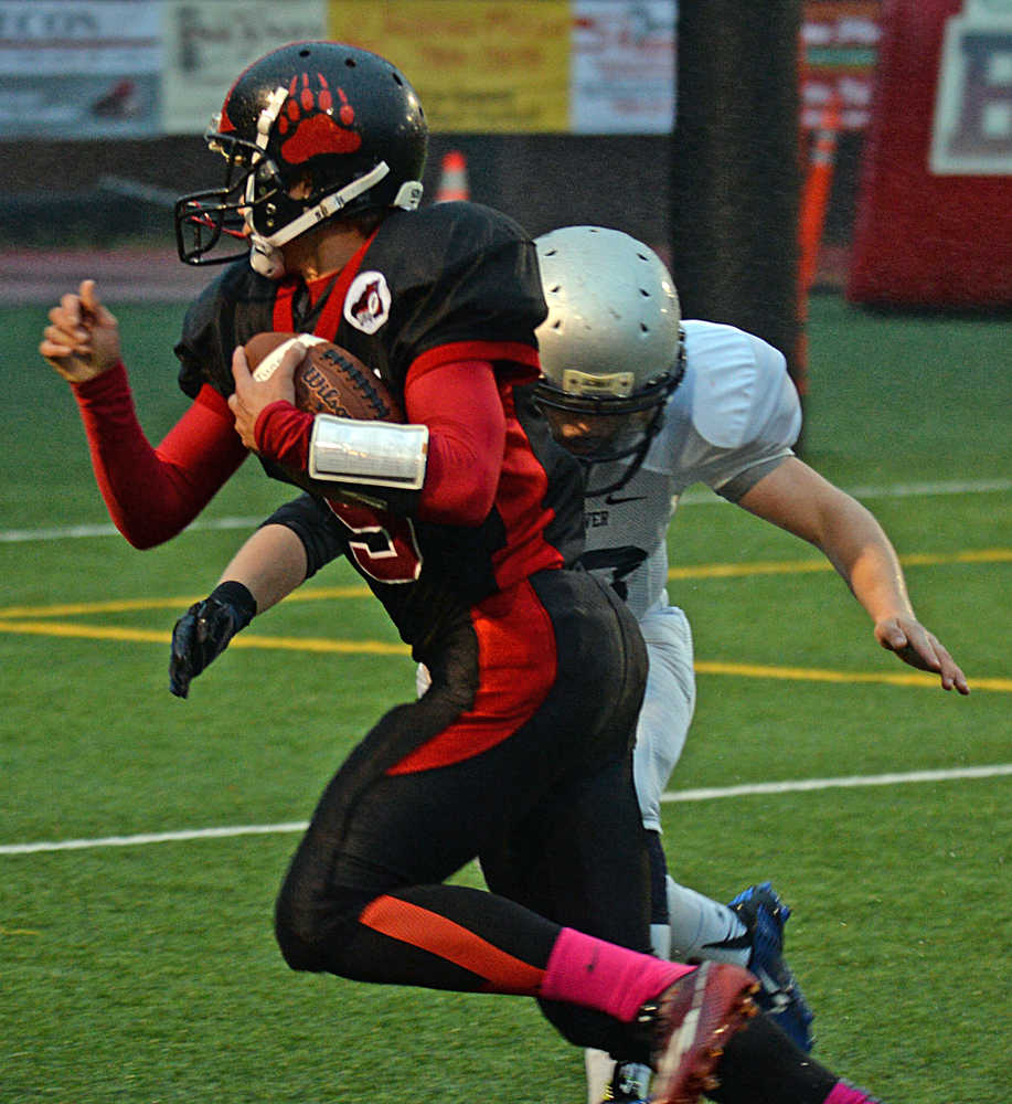 Juneau-Douglas freshman John Hamrick avoids a tackle by Eagle River's Brandon Hill during the Crimson Bears' 41-6 win over the Wolves on Saturday at Adair Kennedy Field.