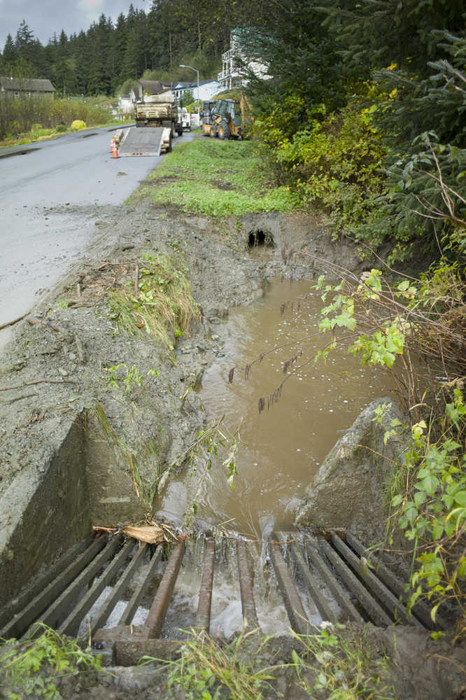 A culvert drain water at Wire Street and Greenwood Avenue after city crews cleared the area after a mudslide on Wednesday.
