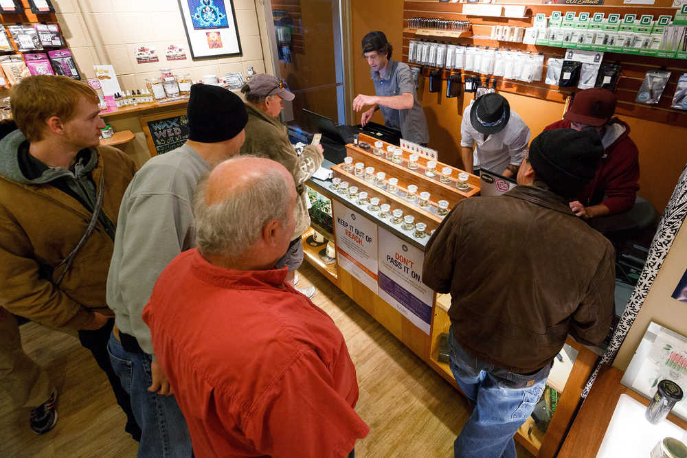Employees of Amazon Organics, a pot dispensary in Eugene, Oregon, help customers purchase recreational marijuana on Thursday. Oregon marijuana shops began selling marijuana Thursday for the first time to recreational users who are at least 21 years old, marking a big day for the budding pot industry.