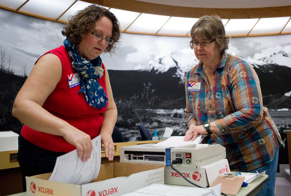 Beth McEwen, left, and Andy Peterson count absentee and questioned ballots in the Assembly Chambers on Friday from Tuesday's municipal election.