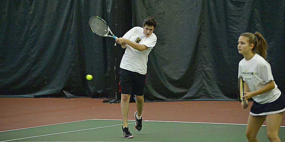 JDHS senior Derek Dzinich returns a shot as freshman mixed doubles partner Erica Hurtte looks on during the team's Region V championships last week. Dzinich will team with classmate Katherine Kane to represent the Crimson Bears at the Alaska School Activities Association state tennis championships this weekend in Anchorage and Hurtte will team with junior Sami Good in girls doubles.