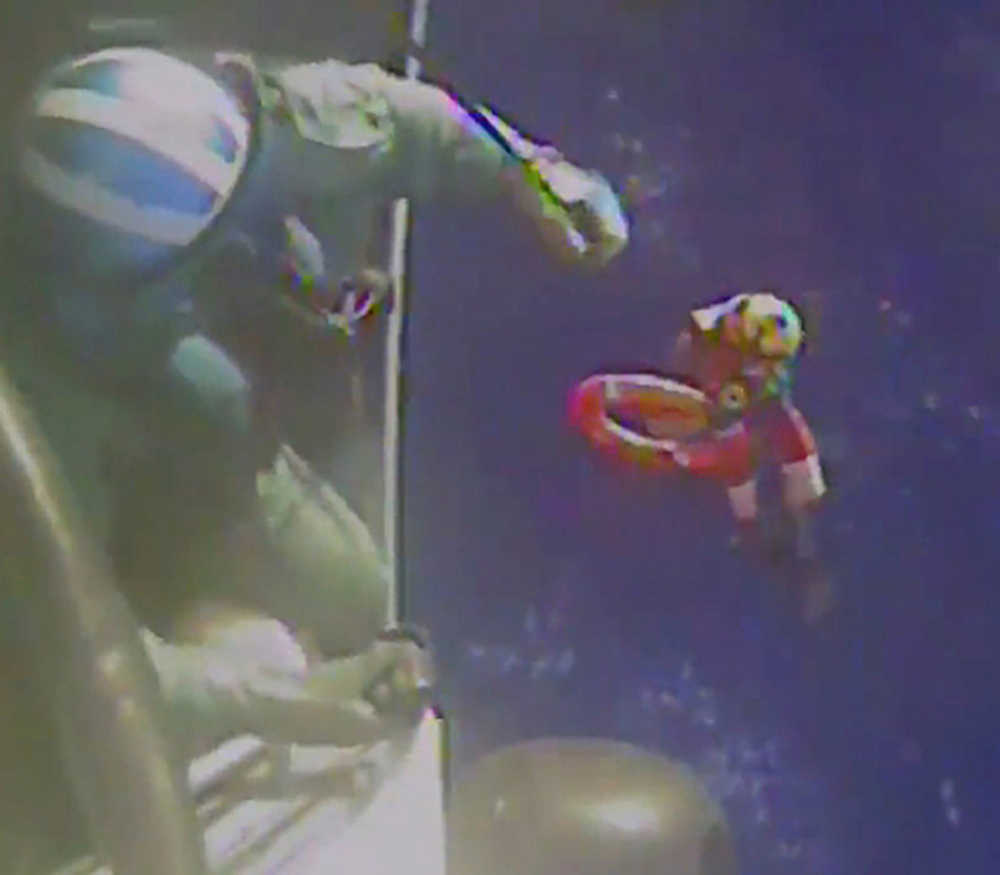 This still image captured Sunday, Oct. 4 made from video and released by the U.S. Coast Guard, shows a Coast Guard Air Station Miami MH-60 Jayhawk helicopter crew as it investigates a life boat that was found from the missing ship El Faro. On Monday, four days after the ship vanished, the Coast Guard concluded it sank near the Bahamas in about 15,000 feet of water. The search continued Tuesday.