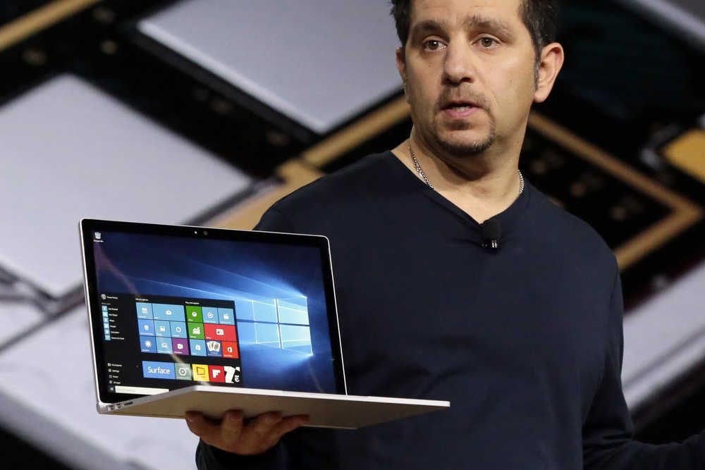 Microsoft vice president for Surface Computing Panos Panay holds a Surface Book laptop during a presentation, in New York, Tuesday. Microsoft says it's for scientists, engineers and gamers who need a lot more performance than a tablet.